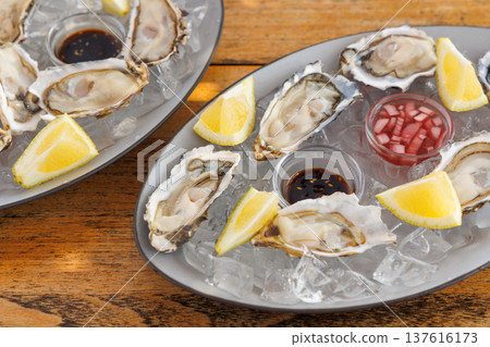 Fresh oysters on ice with champagne Fresh oysters on ice with champagne 137616173
