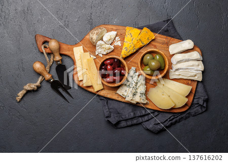Cheese board with assorted cheeses and olives 137616202