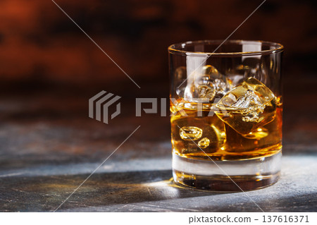 Glass of whiskey with ice 137616371