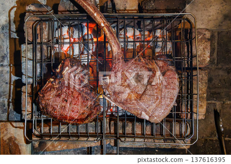 Tomahawk and T-bone steaks grilling top view Tomahawk and T-bone steaks grilling top view 137616395