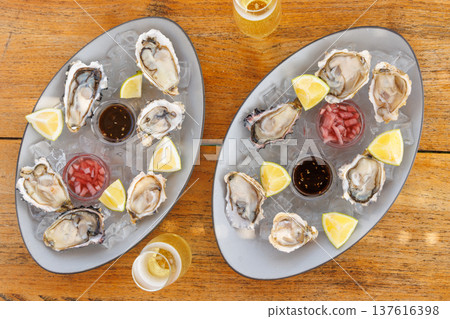 Fresh oysters on ice with champagne 137616398