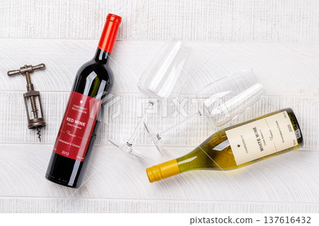 Red and white wine bottles mockup on wood 137616432