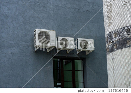 air conditioning on facade of building, air cooling in hot weather. air conditioning on facade of building, air cooling in hot weather. 137616456