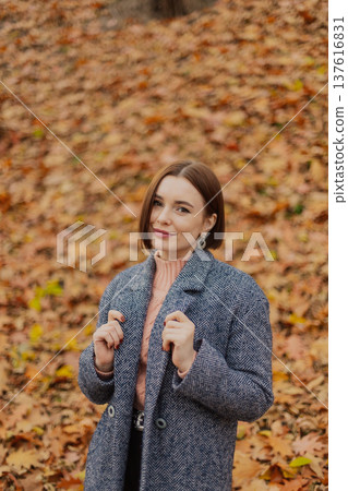 Beautiful young girl posing against the backdrop 137616831