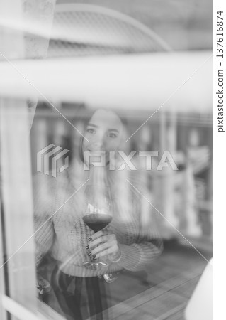 Beautiful young girl sitting at a table in a 137616874