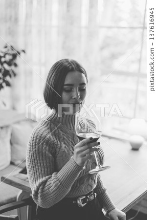 Beautiful young girl sitting at a table in a Beautiful young girl sitting at a table in a 137616945