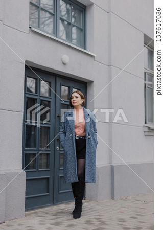 Beautiful young girl standing near wooden door on Beautiful young girl standing near wooden door on 137617086
