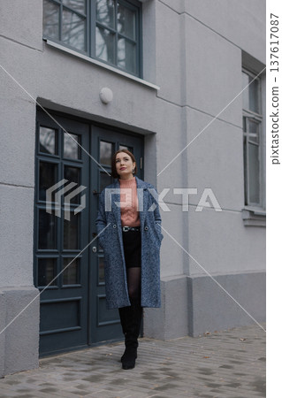 Beautiful young girl standing near wooden door on Beautiful young girl standing near wooden door on 137617087