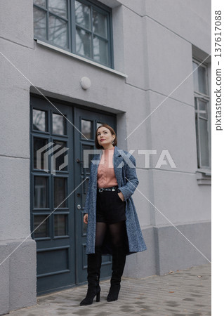 Beautiful young girl standing near wooden door on Beautiful young girl standing near wooden door on 137617088