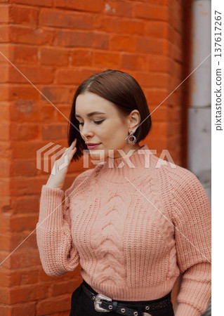 Beautiful young girl posing near red brick wall Beautiful young girl posing near red brick wall 137617267