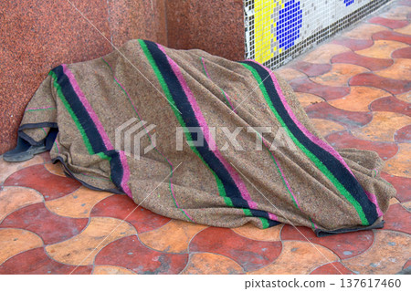 resident sleeps on the floor waiting for the train 137617460