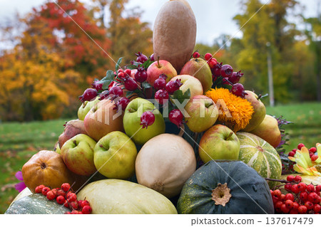 Still life of vegetables, flowers, yellow leaves, fruits in large vase Still life of vegetables, flowers, yellow leaves, fruits in large vase 137617479