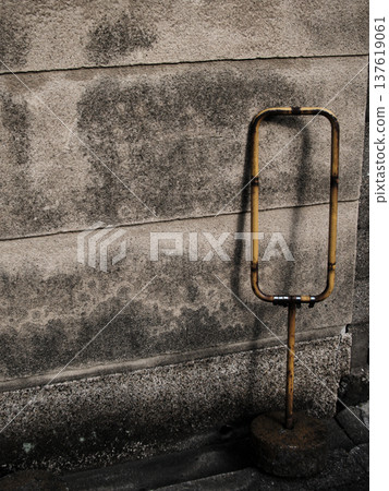 Old concrete wall and rusty iron stand Showa retro back alley scenery background material 137619061