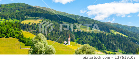 Rural church in green hilly landscape of Dolomites, Winnebach village, Italy. 137619102