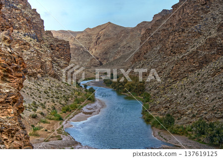Atlas mountains river flowing through a desert canyon Atlas mountains river flowing through a desert canyon 137619125