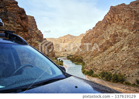 Off road vehicle exploring a desert canyon in morocco Off road vehicle exploring a desert canyon in morocco 137619129