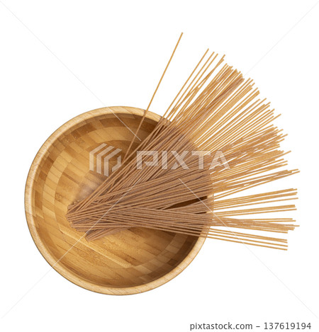 whole wheat spaghetti in a wooden bowl 137619194