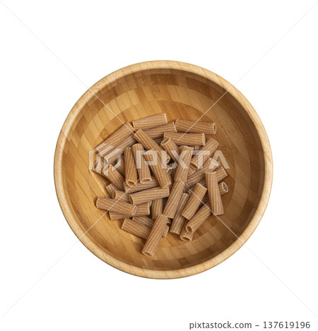 whole wheat rigatoni in a wooden bowl 137619196