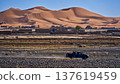 Pickup truck driving on rough desert road in morocco 137619459