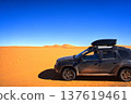 Suv exploring vast desert landscape under blue sky 137619461