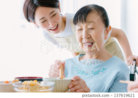 Senior woman having a meal with a caregiver Senior woman having a meal with a caregiver 137619621