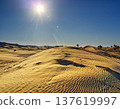 Bright sun shining over golden sand dunes in erg chebi desert 137619997