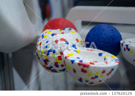 Example object from material expanded polypropylene EPP, universal foam. Durable foam white dog ball toy close-up. Shape of connected balls, multi-colored pattern. New modern industrial technologies. Example object from material expanded polypropylene EPP, universal foam. Durable foam white dog ball toy close-up. Shape of connected balls, multi-colored pattern. New modern industrial technologies. 137620129
