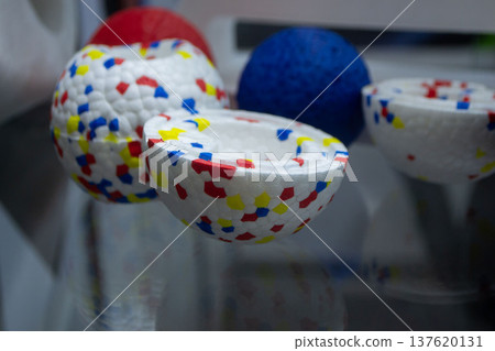 Example object from material expanded polypropylene EPP, universal foam. Durable foam white dog ball toy close-up. Shape of connected balls, multi-colored pattern. New modern industrial technologies. Example object from material expanded polypropylene EPP, universal foam. Durable foam white dog ball toy close-up. Shape of connected balls, multi-colored pattern. New modern industrial technologies. 137620131