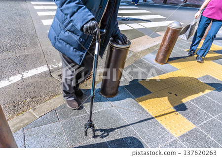 Yokohama cityscape in Japan. Hesitation...steps...fear...elderly man with a cane...a dark shadow sways on the dangerous sidewalk...what is life... 137620263