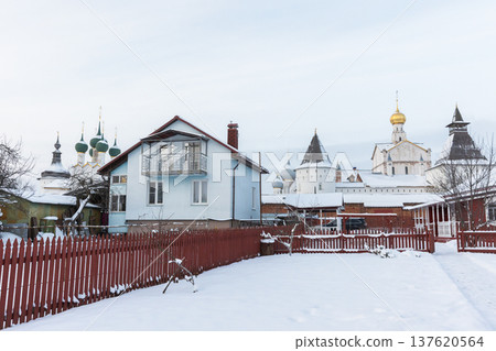 A snow-covered street with wooden houses. Rostov Veliky A snow-covered street with wooden houses. Rostov Veliky 137620564