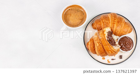 Croissants with chocolate spread and coffee breakfast top view 137621397