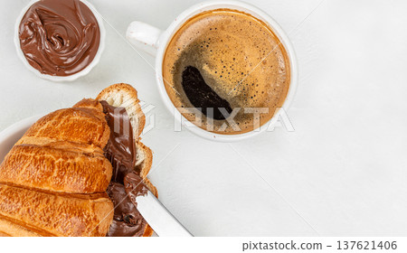 Croissant with chocolate spread and coffee top view breakfast 137621406
