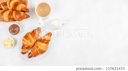 Croissants with coffee chocolate spread and butter breakfast top view Croissants with coffee chocolate spread and butter breakfast top view 137621415
