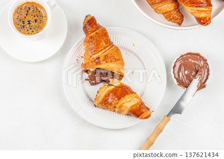 Chocolate croissant breakfast with coffee and spread top view Chocolate croissant breakfast with coffee and spread top view 137621434