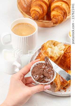 Chocolate spread with croissant and coffee breakfast scene Chocolate spread with croissant and coffee breakfast scene 137621441