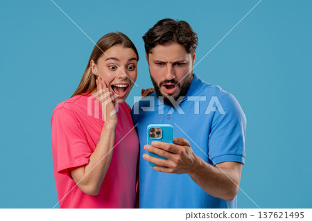 Young Couple Using Mobile Device. Woman Man Watching, Laughing With Smartphone 137621495