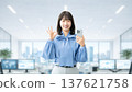 A young woman/businesswoman holding a smartphone and making an OK pose A young woman/businesswoman holding a smartphone and making an OK pose 137621758