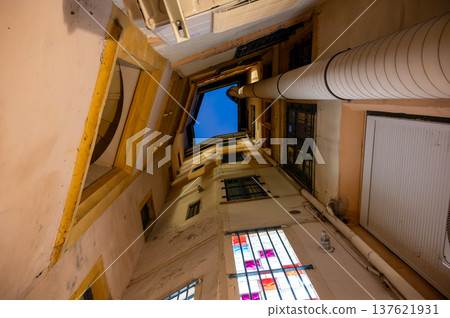 Lyon, france. December 29, 2023. Historic traboule passage with narrow walls reaching up to a deep blue sky, revealing traditional architecture and heritage Lyon, france. December 29, 2023. Historic traboule passage with narrow walls reaching up to a deep blue sky, revealing traditional architecture and heritage 137621931