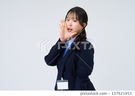 A business woman who poses with her hand on her mouth A business woman who poses with her hand on her mouth 137621955