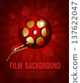 Vector film background with film reel and golden filmstrip on red background. Shiny cinema poster with flashlights 137622047
