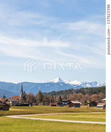 Village church and snowy mountain view in Garmisch-Partenkirchen, Bavaria, Germany Village church and snowy mountain view in Garmisch-Partenkirchen, Bavaria, Germany 137623396