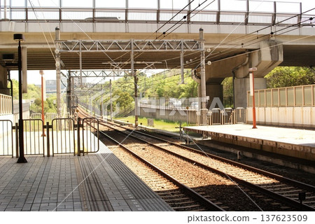 Scenery of the railway tracks and station running under the bridge Scenery of the railway tracks and station running under the bridge 137623509