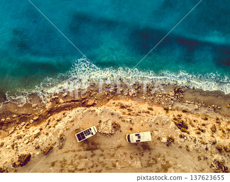 Two caravans solar panels on roof camp on seashore. Aerial view 137623655