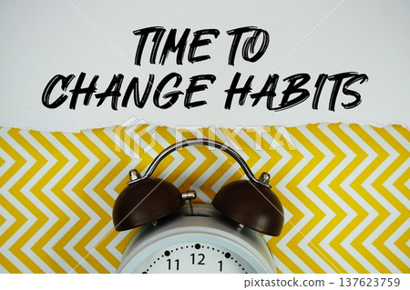 Time to Change Habits text written on paper rip with alarm clock flat lay on yellow chevron background Time to Change Habits text written on paper rip with alarm clock flat lay on yellow chevron background 137623759
