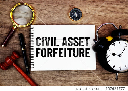 Civil Asset Forfeiture message written on notepad with alarm clock, wood gavel and magnifying glass flat lay on wooden background Civil Asset Forfeiture message written on notepad with alarm clock, wood gavel and magnifying glass flat lay on wooden background 137623777