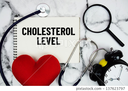 Cholesterol Level text written on notepad with red heard and stethoscope on marble background Cholesterol Level text written on notepad with red heard and stethoscope on marble background 137623797
