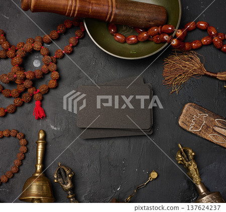 Blank black business cards in the center surrounded by a Tibetan singing bowl, prayer drum, bells Blank black business cards in the center surrounded by a Tibetan singing bowl, prayer drum, bells 137624237