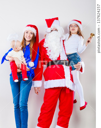 Mother, Santa and two daughters christmas family photo Mother, Santa and two daughters christmas family photo 137624257