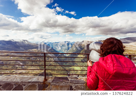 Tourist looking through binoculars in mountains, Norway Tourist looking through binoculars in mountains, Norway 137624822