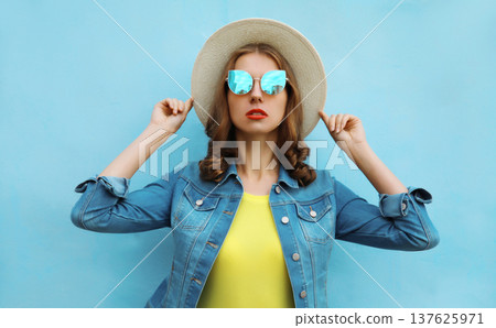 Summer portrait of young woman in summer straw hat with sunglasses Summer portrait of young woman in summer straw hat with sunglasses 137625971